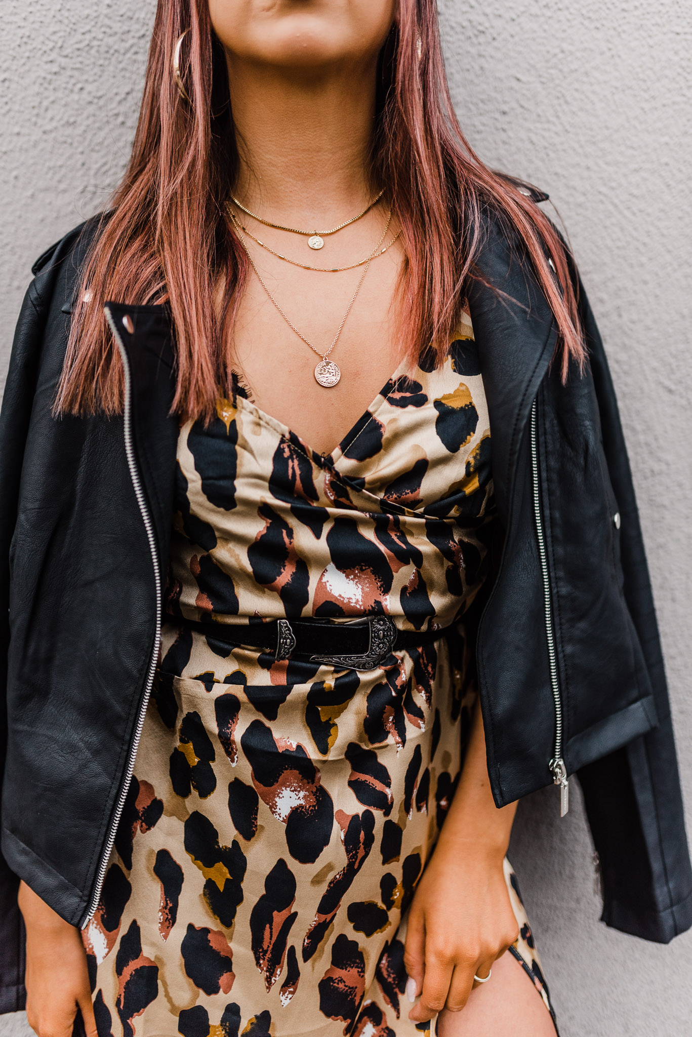 Detail shot of fashion blogger wearing cheetah print dress.