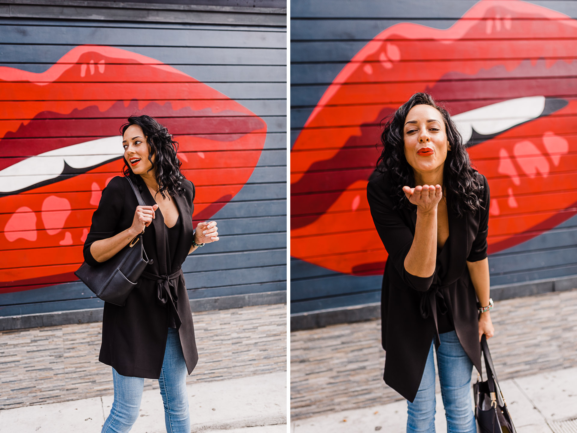 Woman walking down sidewalk in front of a red lipstick mural. She's wearing a black shirt, black blazer, and jeans.