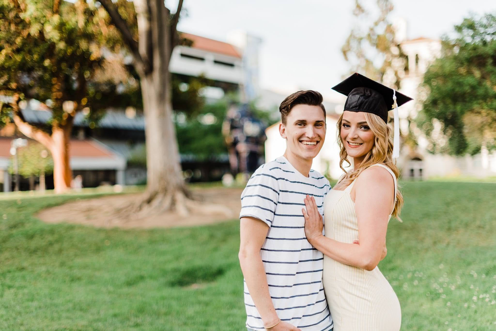 Couple, woman wearing graduation cap
