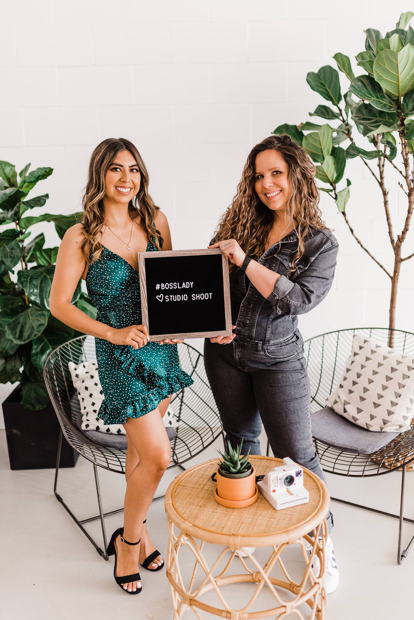 Two bloggers posed with a letter board that says "#BossLady Studio Shoot."