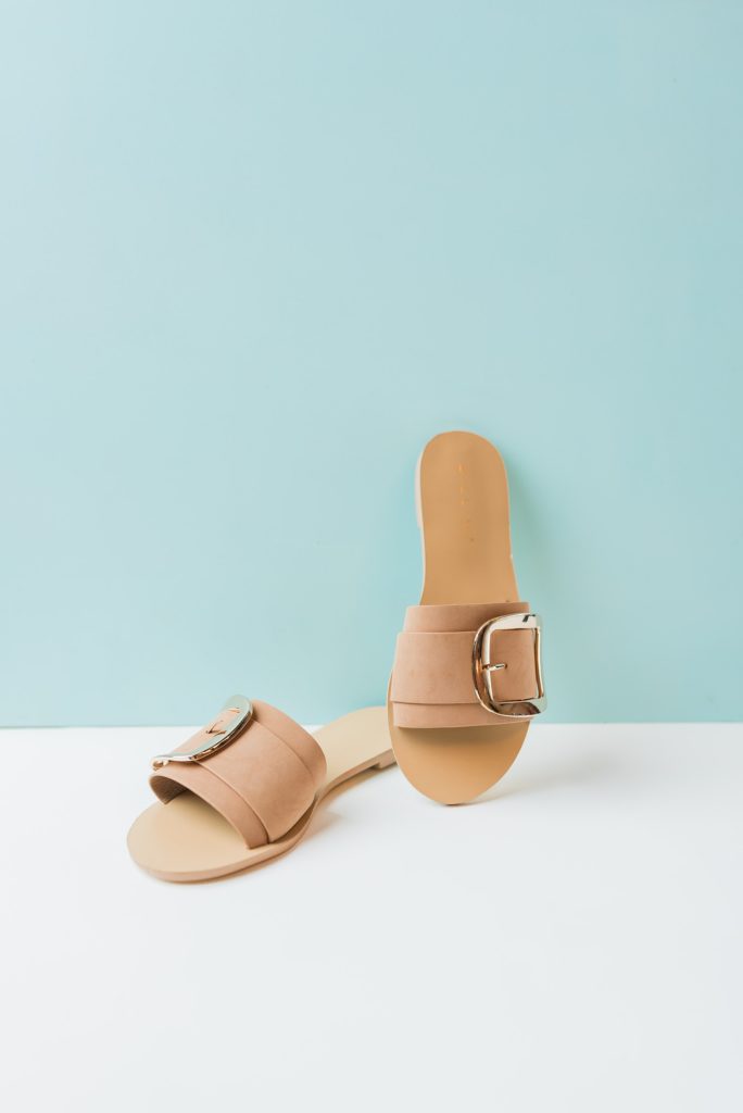 Tan belted sandal slides.