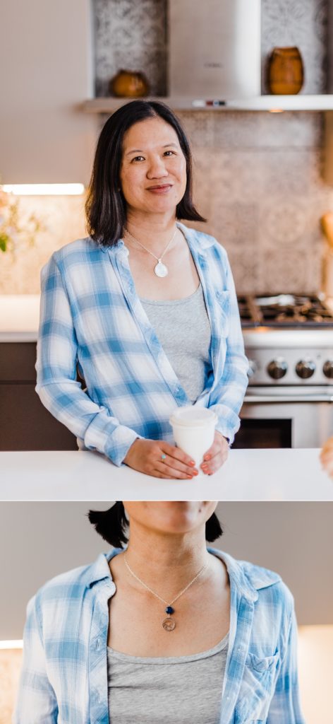 A woman wearing a silver pendant necklace in the kitchen.