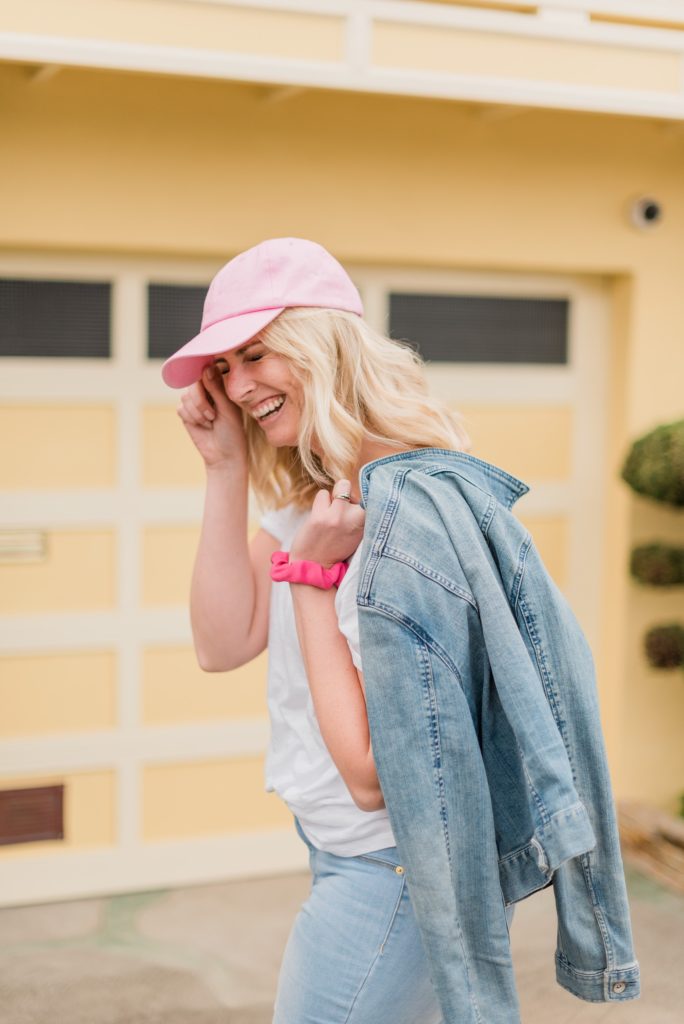 laughing branding shot with hat and denim jacket over the shoulder