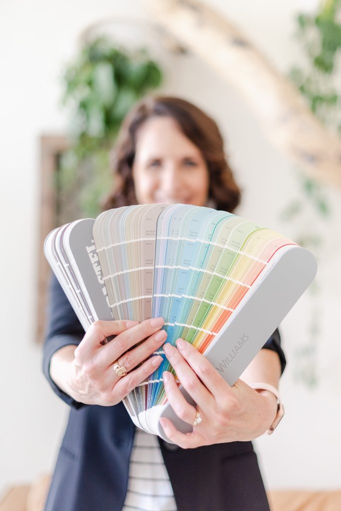woman holding a packet of paint samples.