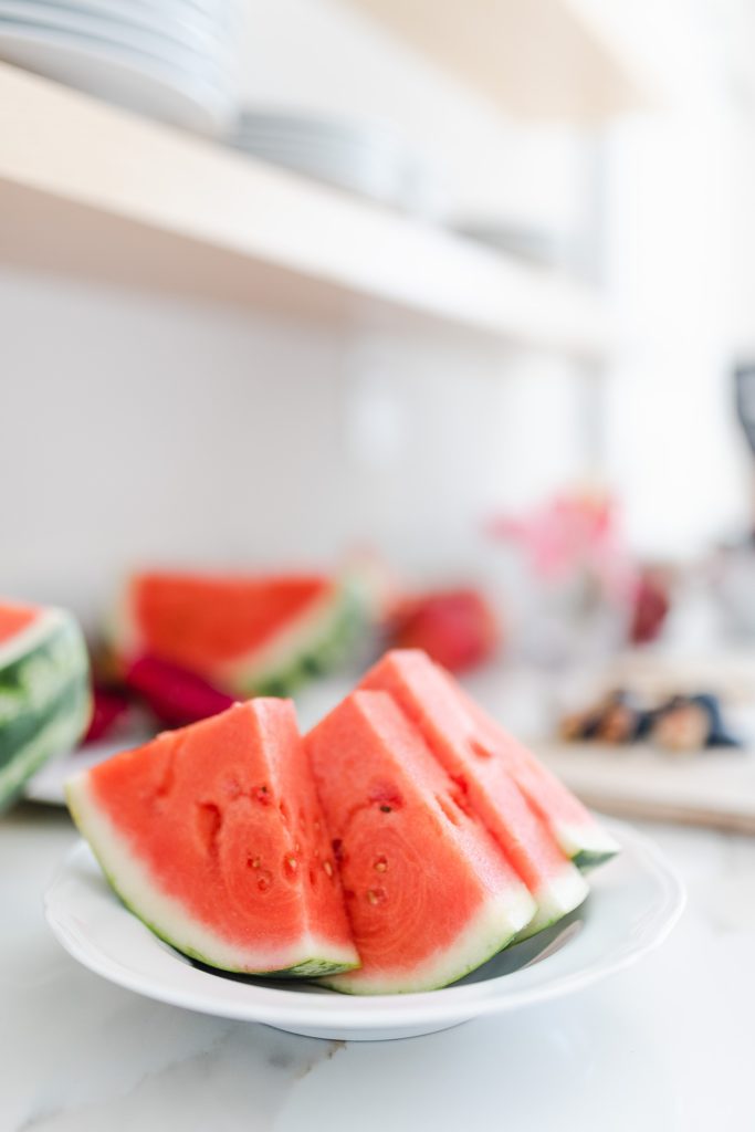 Four triangle slices of watermelons on a plate.