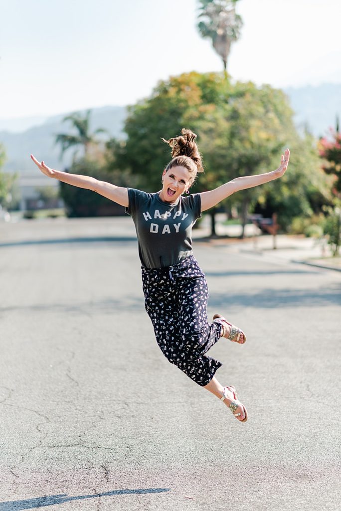 jump shot of a woman in the middle of the road