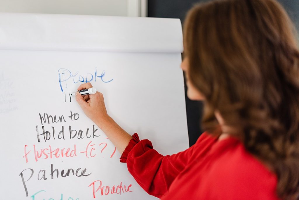 woman writing something on a board