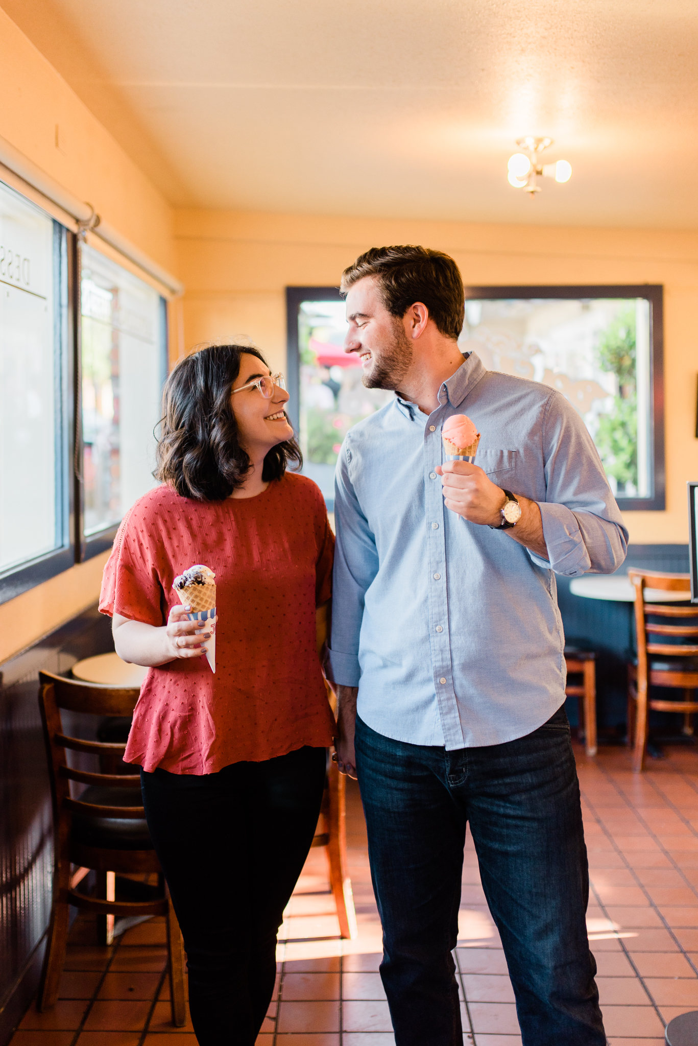 a couple looking at each other with ice cream