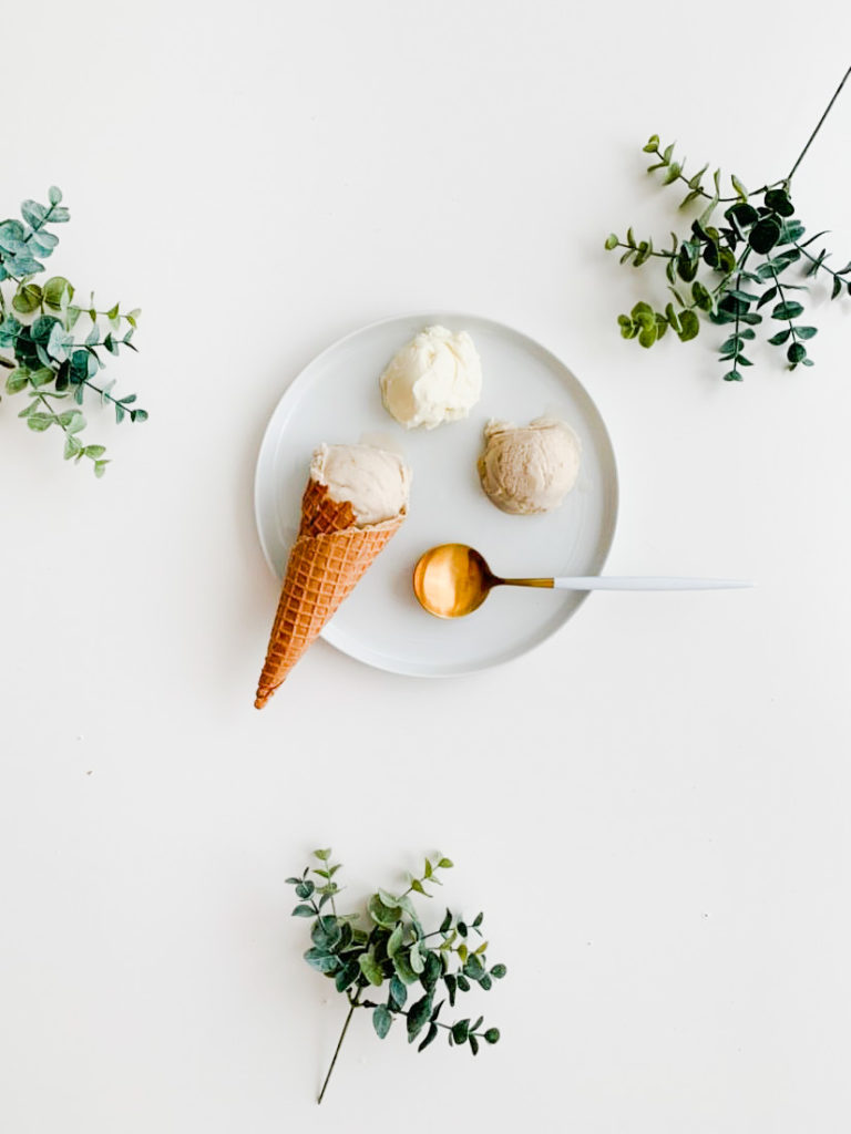 3 scoops of gelato on a plate. one is in a cone.