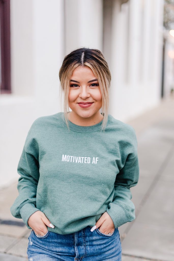 woman wearing "motivated AF" sweatshirt