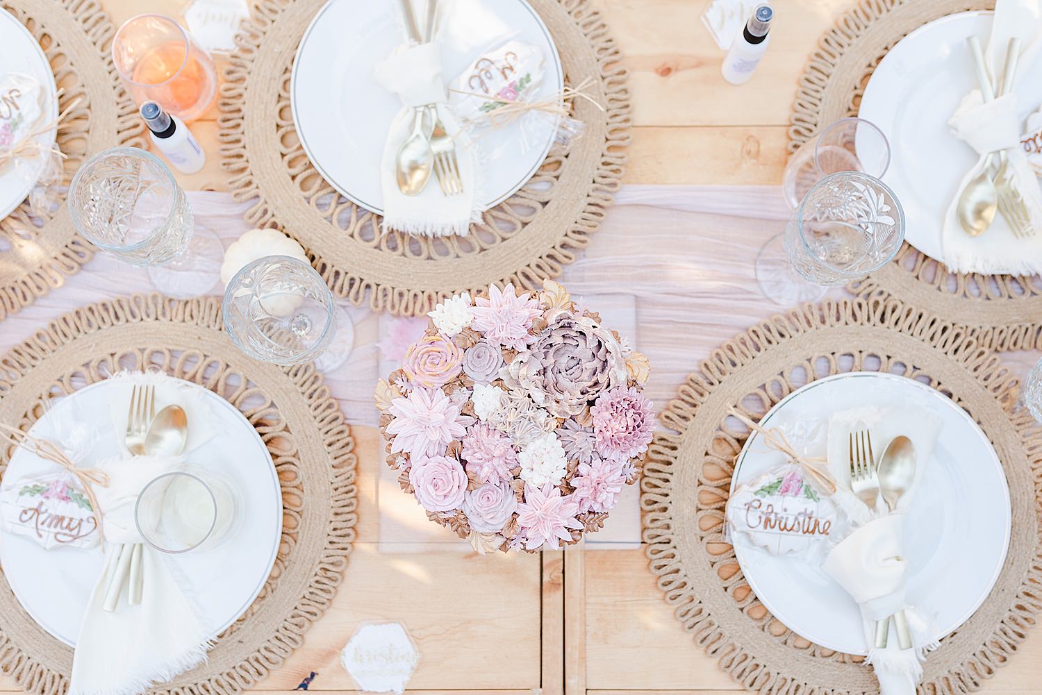 flatlay image of a table setting with a bunch of flowers in the middle