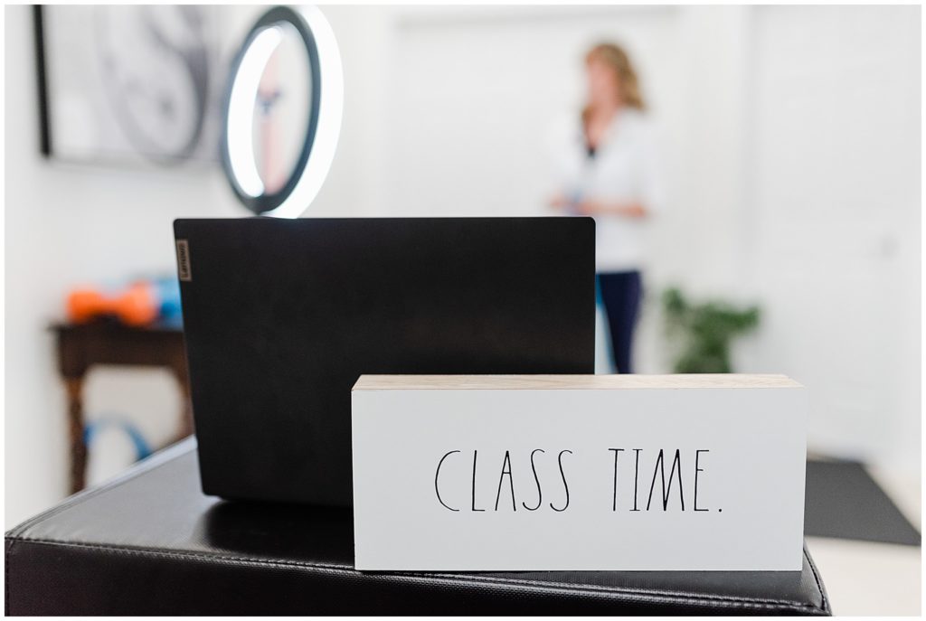 white block of wood that says "class time" with a laptop behind it.