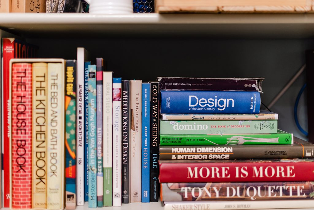 section of a shelf filled with books about design and architecture