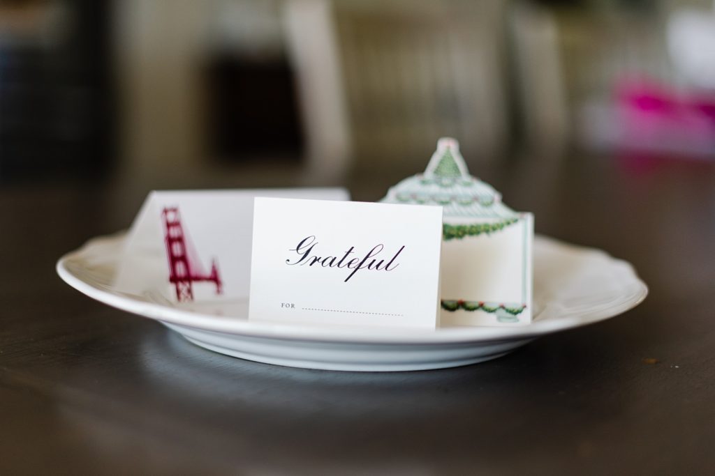name card with the word "Grateful" in it on top of a white plate