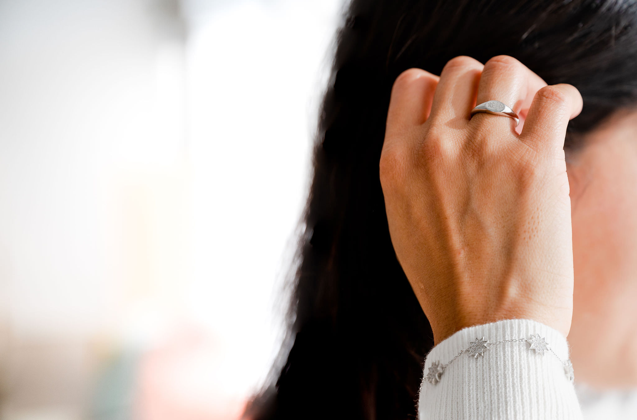 woman wearing a silver Bahai ring and pendant bracelet