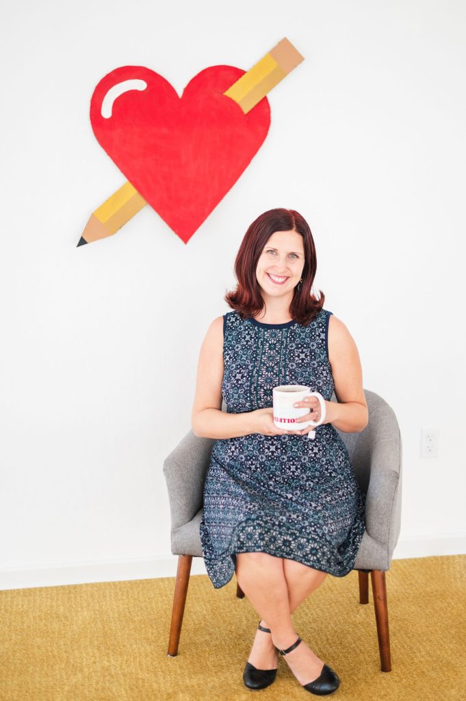 Lily Jones Educator Forever Sitting Below a Large Red Heart with a Pencil