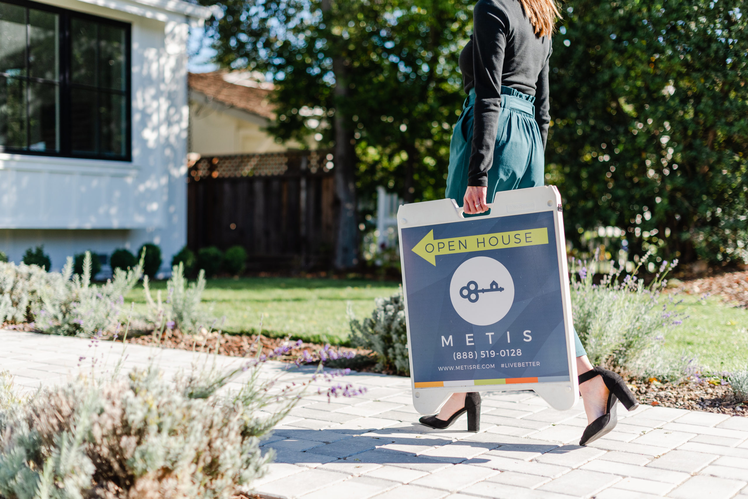 Realtor carrying open house sign