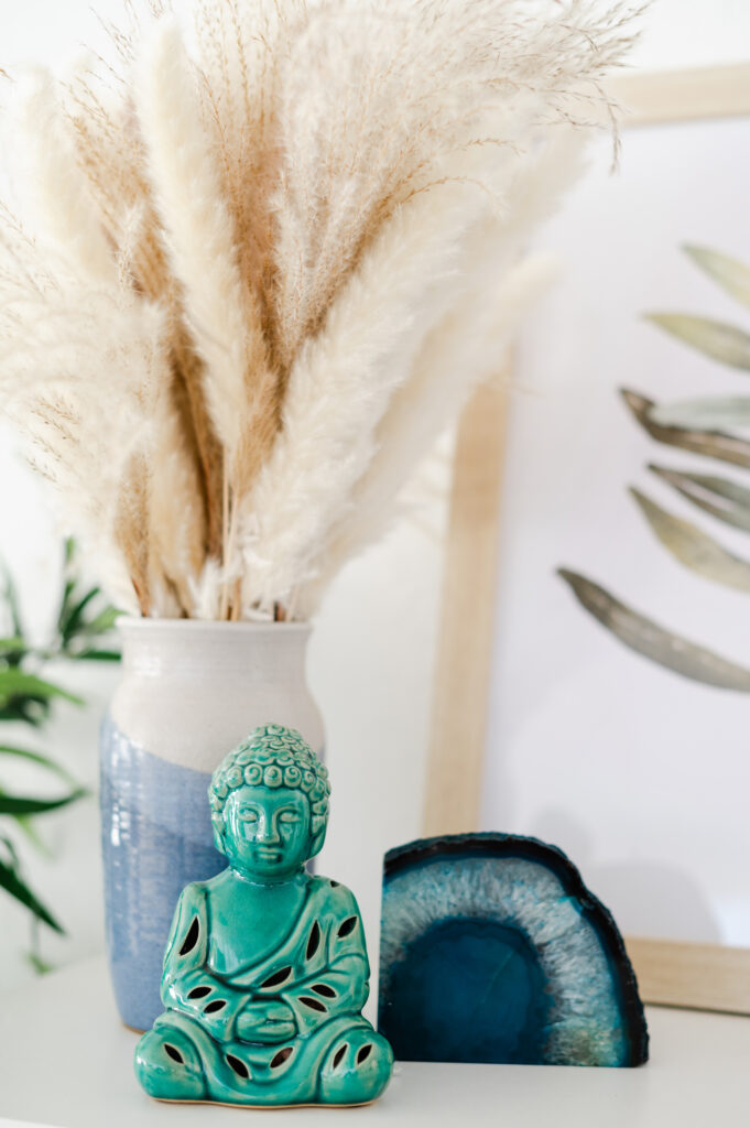 Detail shots of spiritual items - ceramic Buddha and crystal