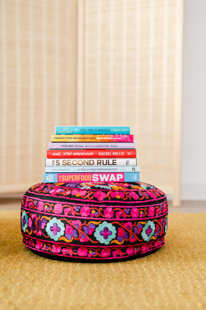 Stack of wellness books on top of a meditation pillow