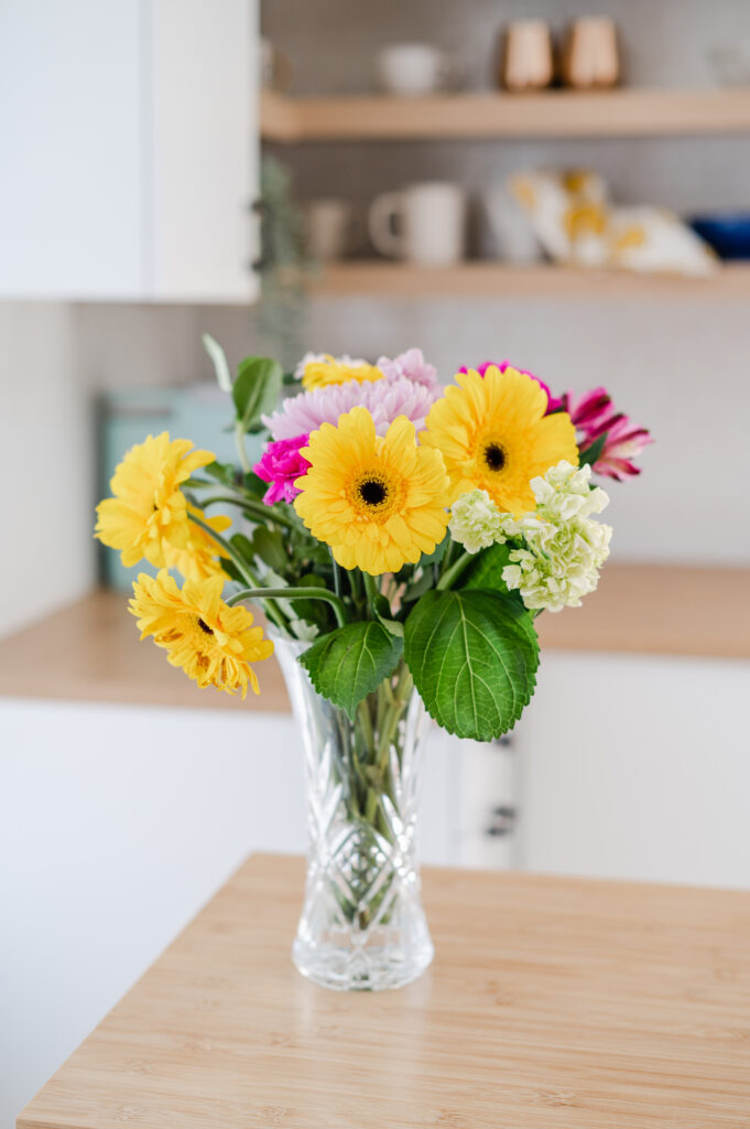 Close up of flowers in a vase in a kitchen