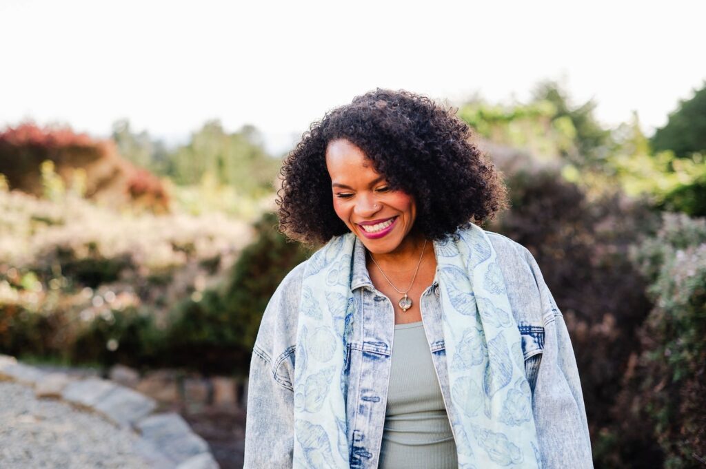 woman looking down and laughing