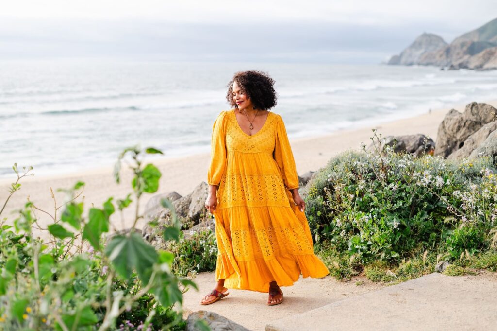 woman in a yellow dress at the beach on the west coast